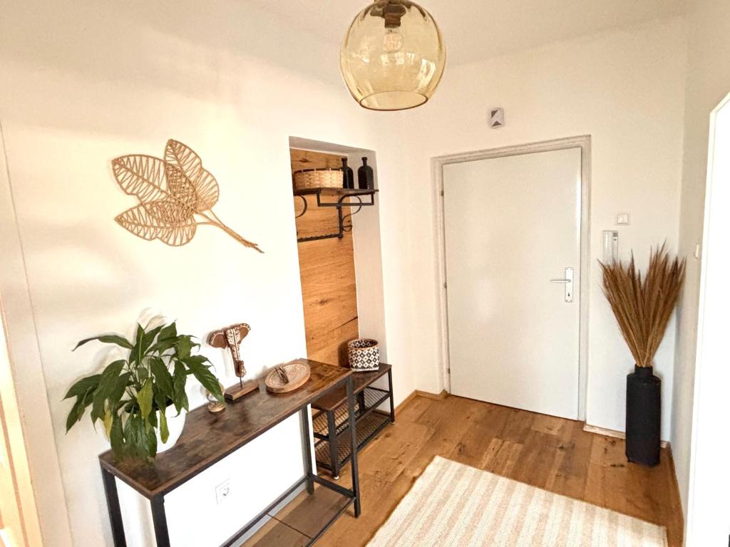 a room with a table and a butterfly on the wall at WestSideStory - Apartment zwischen Wörthersee & City in Klagenfurt
