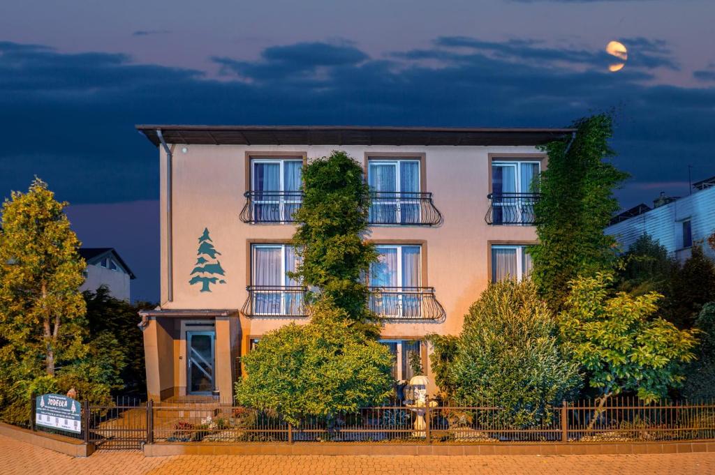 a building with a christmas tree in front of it at O. W. Jodełka in Łeba