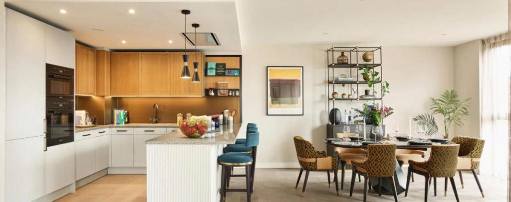 a kitchen and dining room with a table and chairs at Merino Gardens Deluxe 3 Bed by Tower Bridge in London