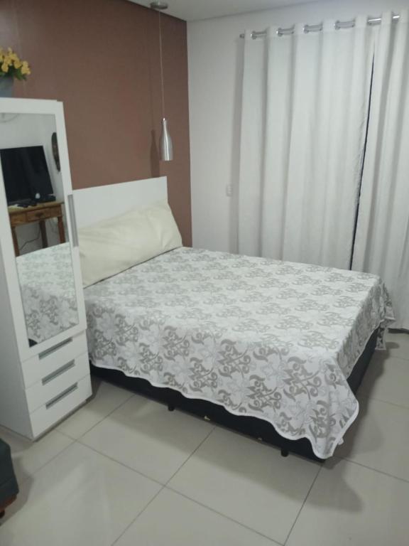 a small bedroom with a bed and a dresser at Ap mobiliado reg central de São Paulo in São Paulo