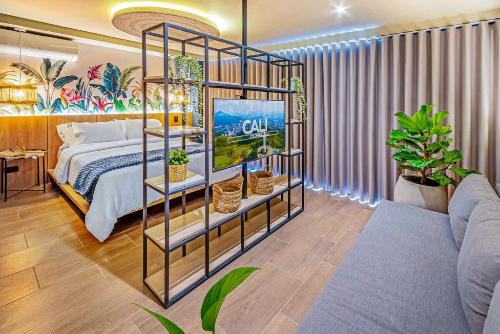 a bedroom with a bed and a room with plants at H201 I Luxury Loft I Central I Balcony With Views in Cali