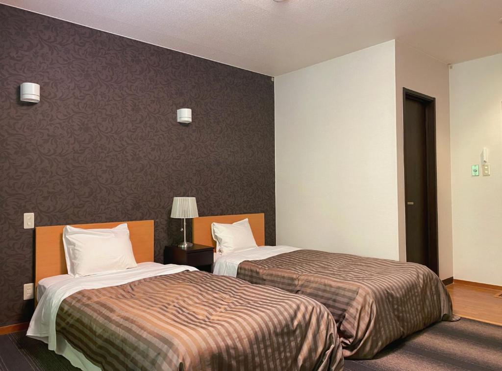 Postel nebo postele na pokoji v ubytování Itoen Hotel Shima