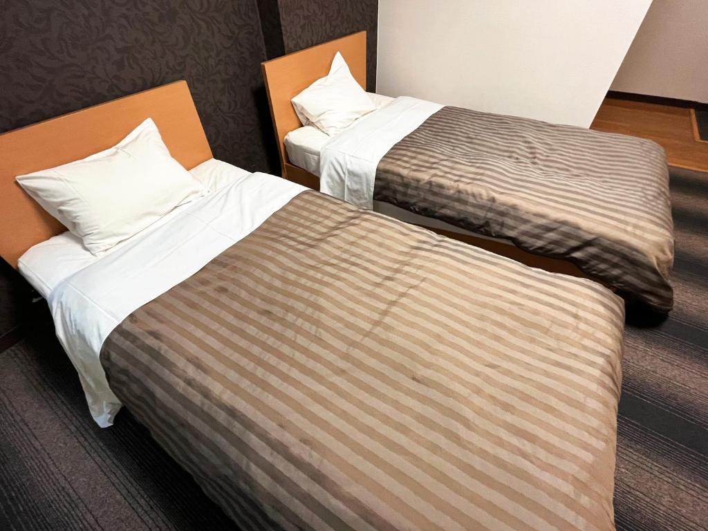 Postel nebo postele na pokoji v ubytování Itoen Hotel Shima