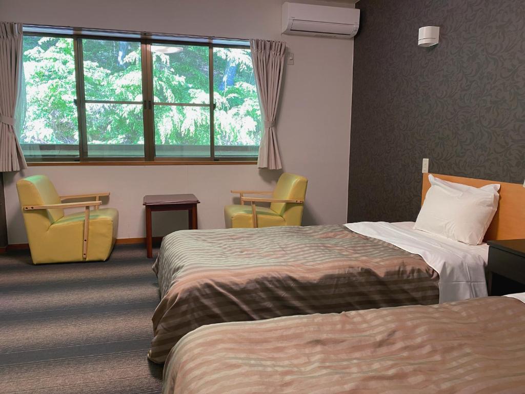 Postel nebo postele na pokoji v ubytování Itoen Hotel Shima