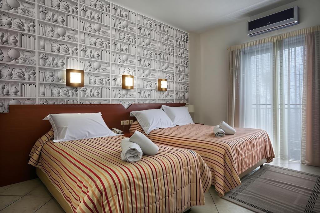 Łóżko lub łóżka w pokoju w obiekcie City Life Port Hotel