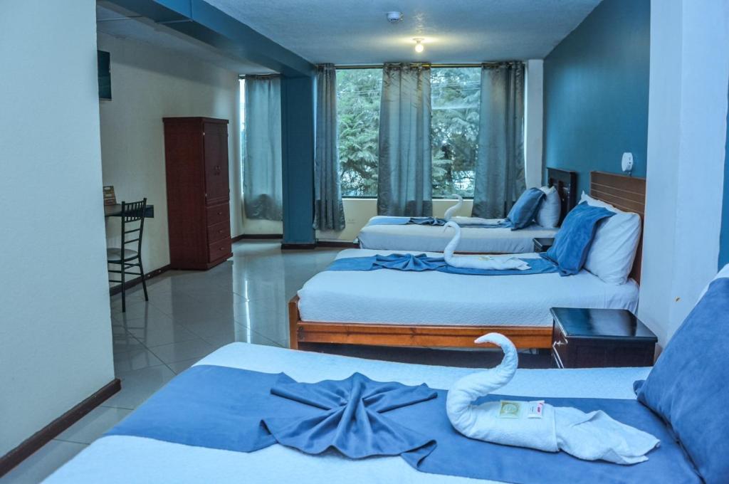 Postel nebo postele na pokoji v ubytování Hotel Miraflores
