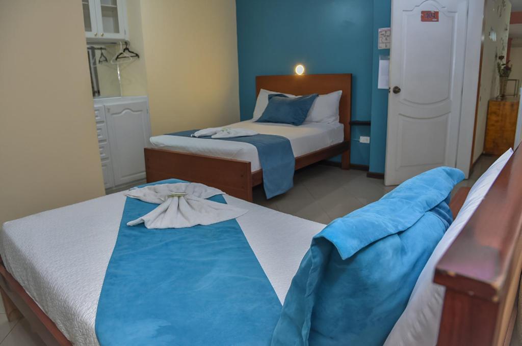 Postel nebo postele na pokoji v ubytování Hotel Miraflores