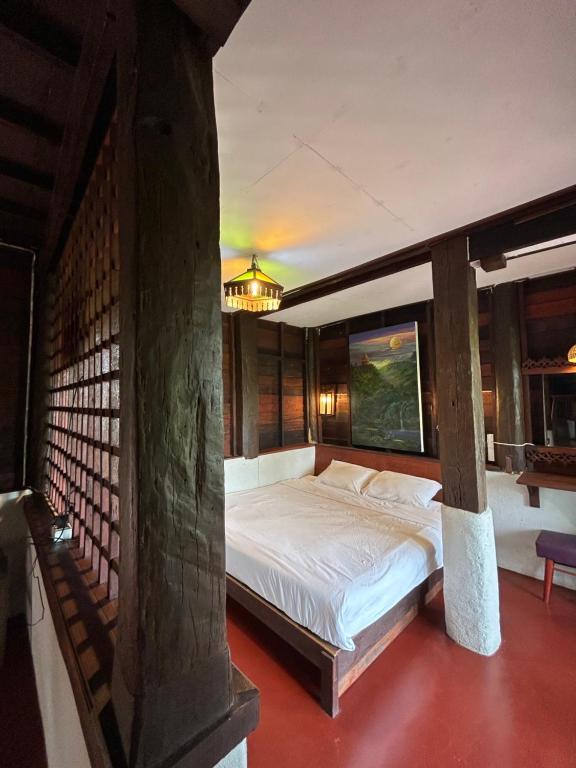 a bedroom with a large bed in a room at Boon Homestay & Cafe บุญโฮมสเตย์ in Ban Buak Khang