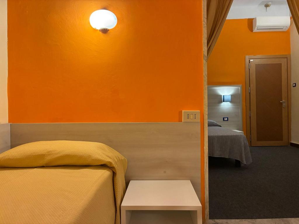 Postel nebo postele na pokoji v ubytování Hotel Annunziata
