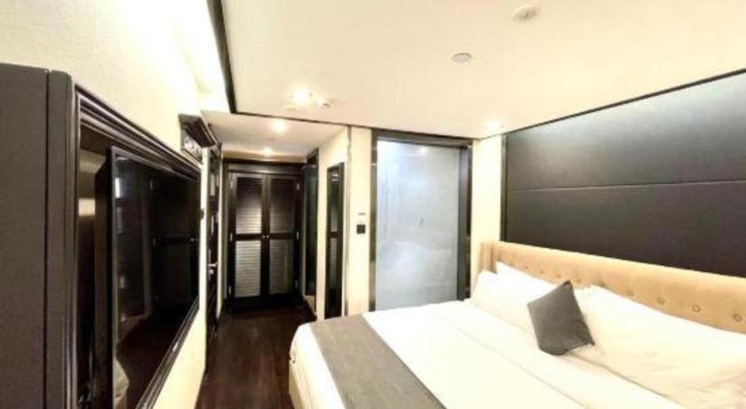 a bedroom with a large bed with a black headboard at Xana Hotelle Xiamen Airport Zone Government in Xiamen