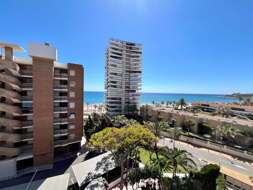 an aerial view of a building and the beach at Apartmento Av Costa Blanca Playa de San Juan in Alicante