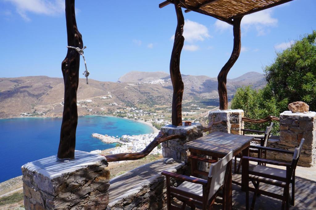 a porch with chairs and a view of a lake at Pano Gitonia in Aegiali