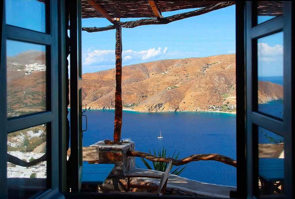 a view of a lake from a window at Pano Gitonia in Aegiali