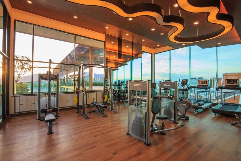 a gym with a bunch of exercise equipment in a building at The Astra Condo, Downtown in Chiang Mai