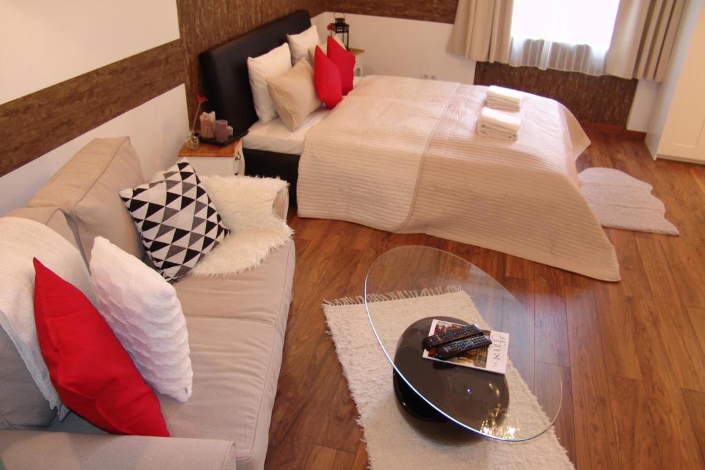 a living room with a bed and a couch at Romantic Centrum Apartman in Budapest