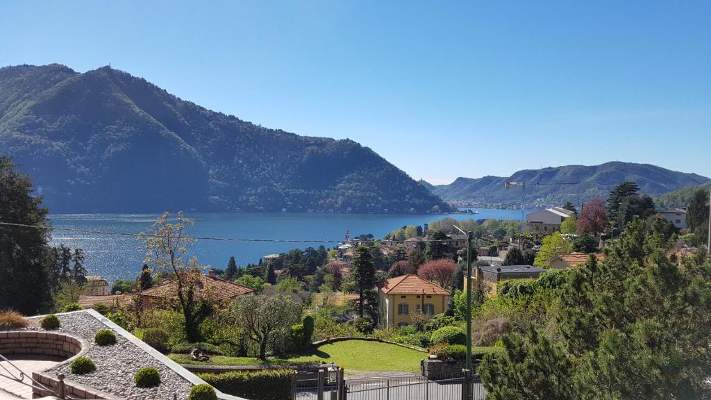 a view of a town with a lake and mountains at La Finestra Sul Lago in Cernobbio