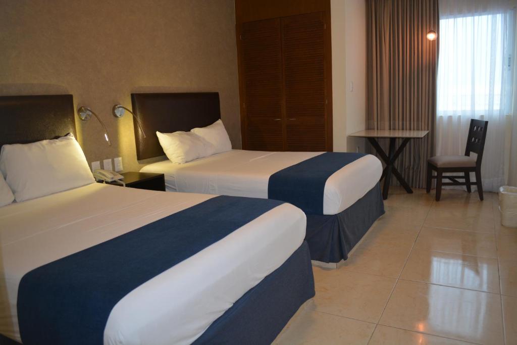 Postel nebo postele na pokoji v ubytování Hotel Ruiz Milán
