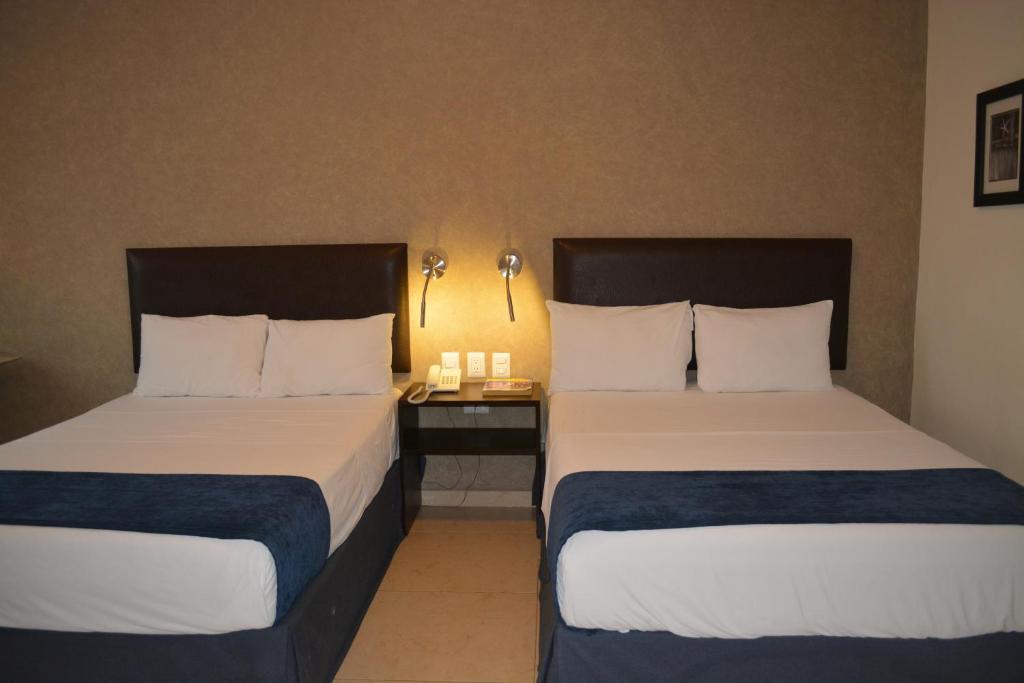 Postel nebo postele na pokoji v ubytování Hotel Ruiz Milán