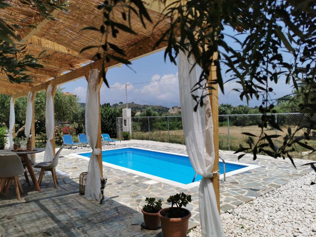 a view of a swimming pool with a pergola at Kefalonia Olive House private pool in Xi