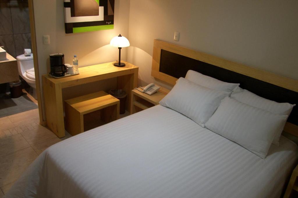 Postel nebo postele na pokoji v ubytování Rymma Hotel