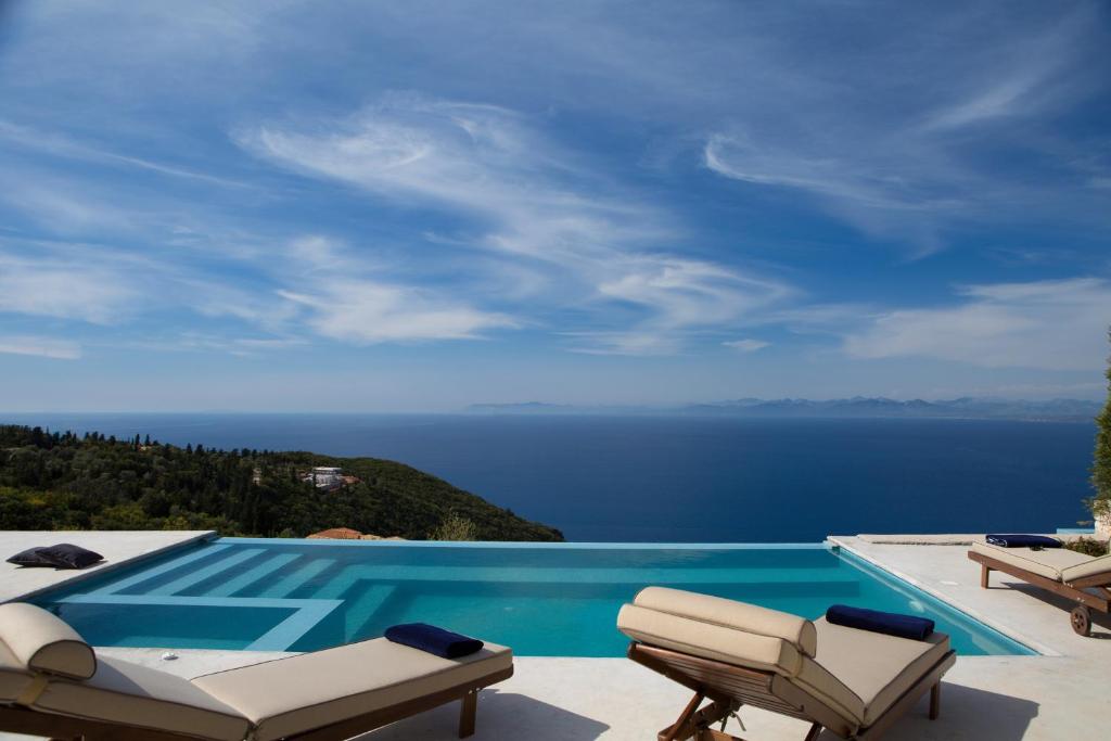 a swimming pool with a view of the ocean at Ionian Horizon Villas in Tsoukalades