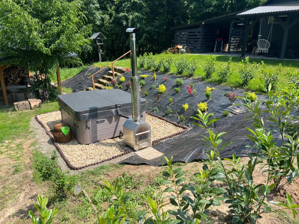 a garden with a grill and some flowers at Siedlisko Wyżne in Wyżne