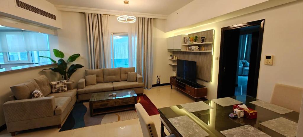 a living room with a couch and a table at JLT 1BR Marina Skyline View in Dubai