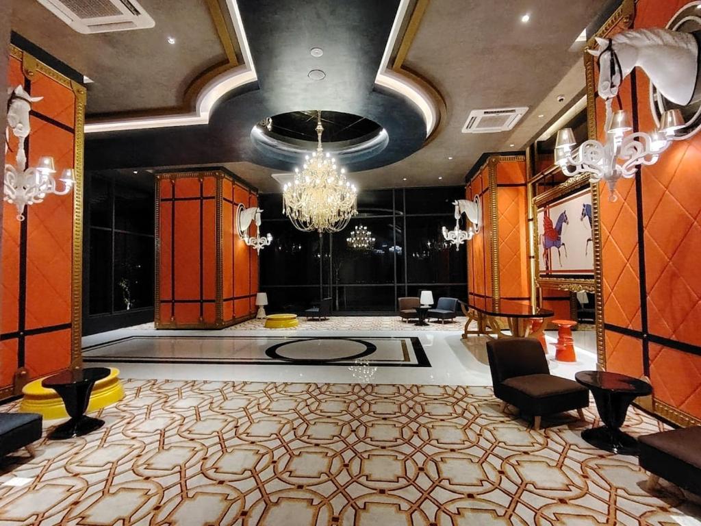 a lobby with a large room with a chandelier at 1-12PAXKuala Lumpur Near Taman MIDAH Cheras 2 Car Parking normally 1 parking only in Kuala Lumpur