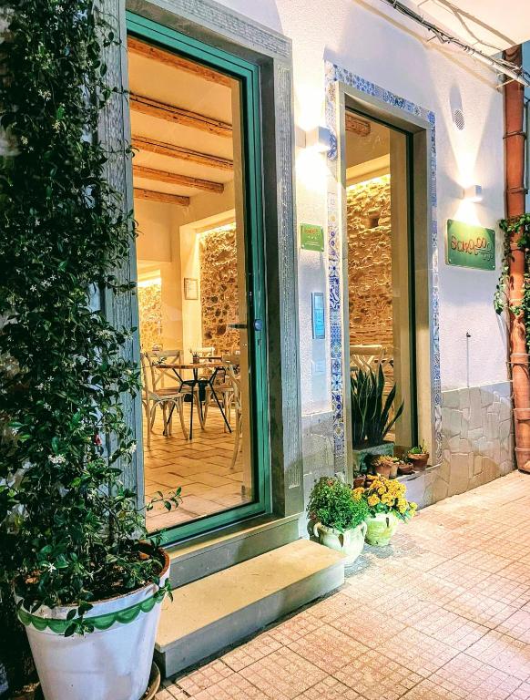 a front door of a building with potted plants at Scirocco Affittacamere in Oliveri