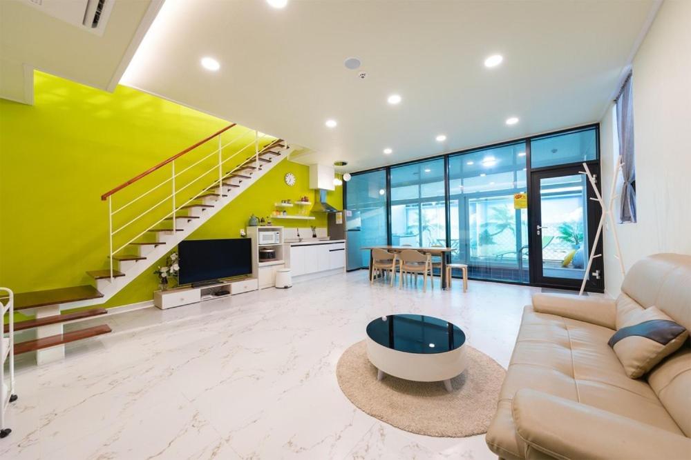 a large living room with a couch and a staircase at Paju Hey-ri Wolabal in Paju