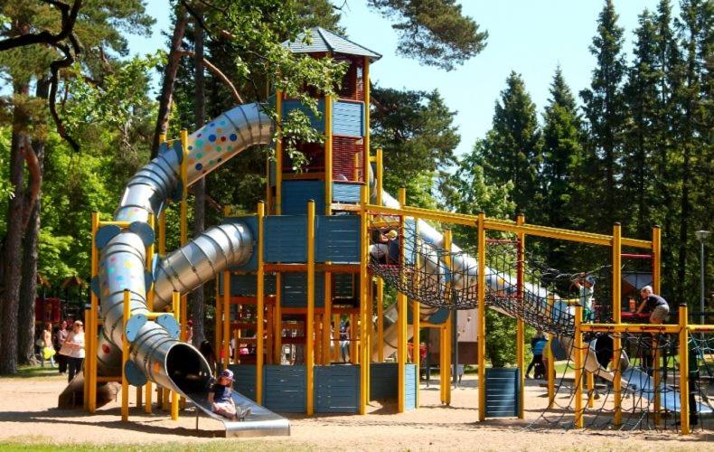 a playground with a slide in a park at KunK in Ventspils
