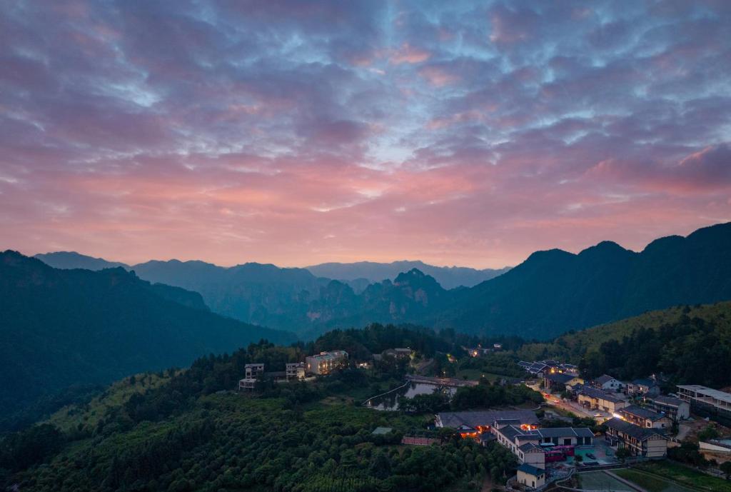 a view of a town in the mountains at sunset at Hallelujah Heights Retreat in Zhangjiajie