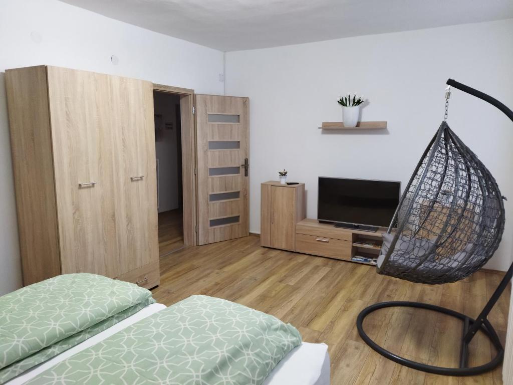 a bedroom with a bed and a net swing at Sarokház Apartman in Sátoraljaújhely
