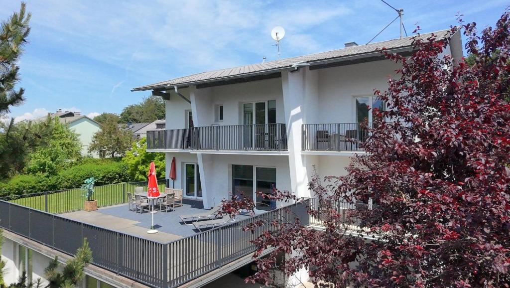 a large white house with a tree in front of it at Villa Mira in Klopein am Klopeiner See