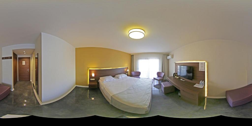 Postel nebo postele na pokoji v ubytování Neopol Hotel