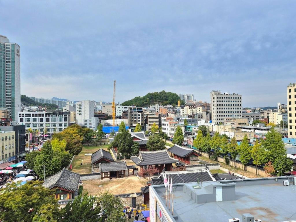 a view of a city with buildings and trees at Dongdaemun Myeongdong 6BED in Seoul