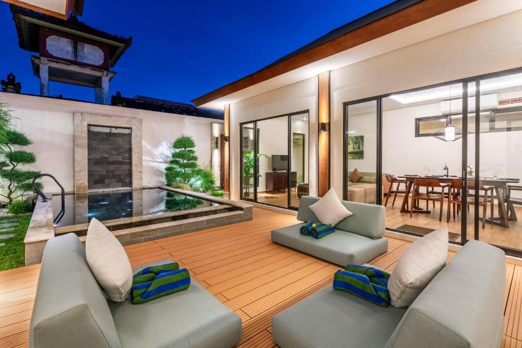 an outdoor living room with chairs and a table at Oasis Residences - Limited Luxury Villas - Reserve Today! in Sanur