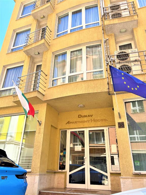 a building with a flag in front of it at Dunav Apartment House in Sofia