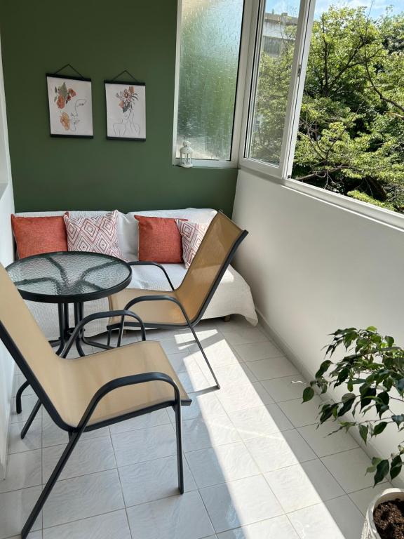 a living room with a couch and a table and chairs at Nana's apartment in Varna City
