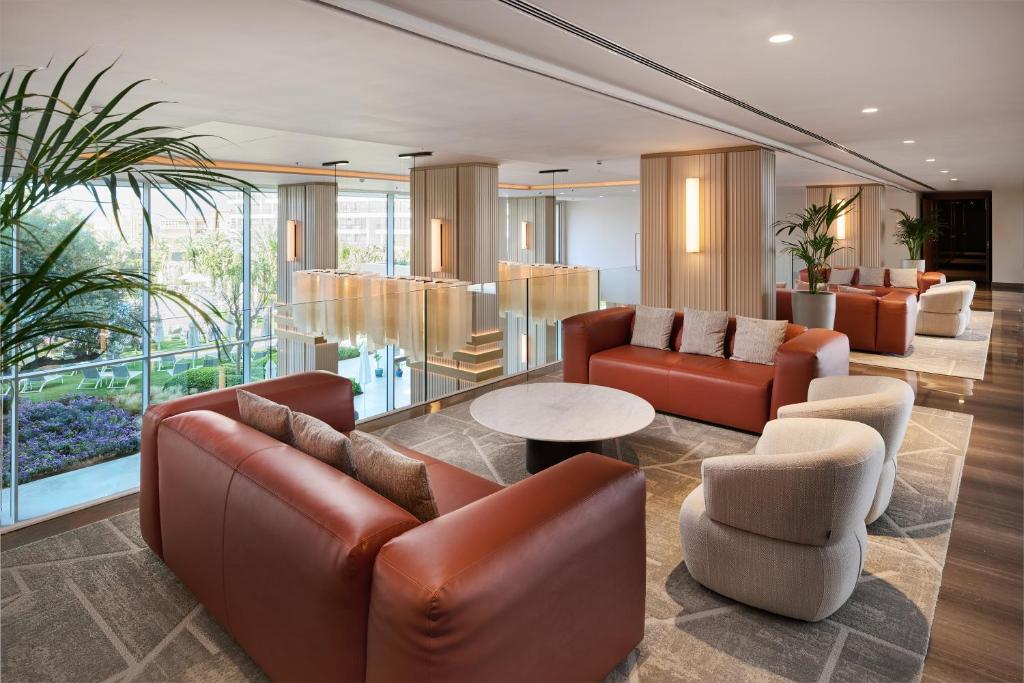 a lobby with couches and chairs and a table at Hipotels Playa de Palma Palace&Spa in Playa de Palma