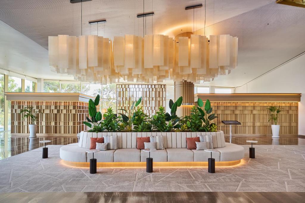 a living room with a white couch in a lobby at Hipotels Playa de Palma Palace&Spa in Playa de Palma