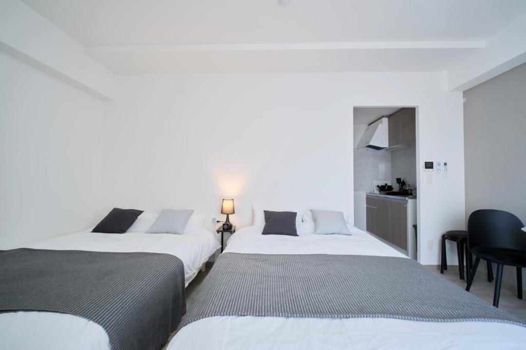 Postel nebo postele na pokoji v ubytování Junction Namba South Hotel Apartment ジャンクション難波南ホテルアパートメント