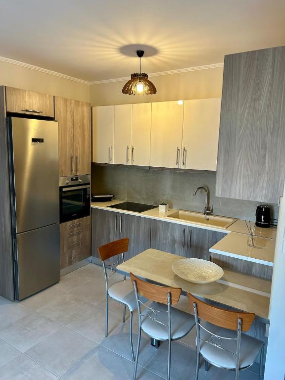 a kitchen with a table and chairs and a refrigerator at Serenity in Kefalos