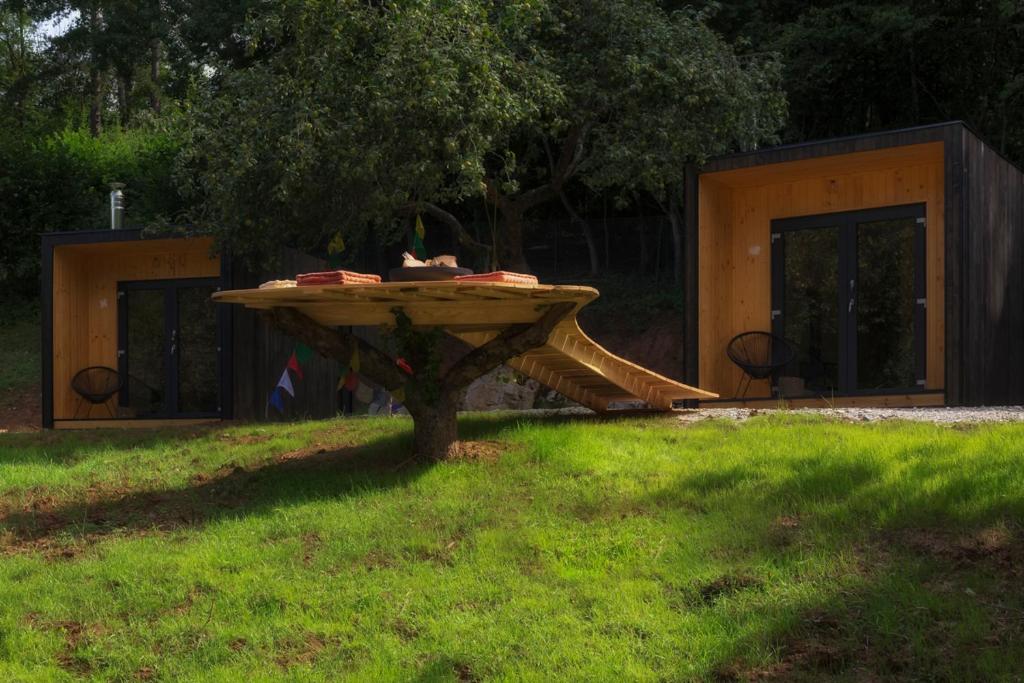 a playground with a slide in the grass at Camping centra Shambhala in Lúčka