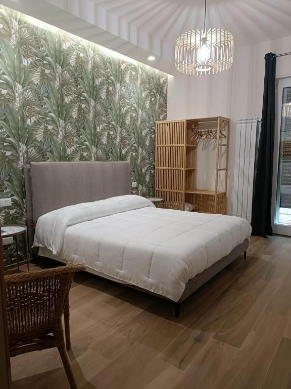 a bedroom with a large bed and a wall mural at PIANESE house 1 in Campobasso