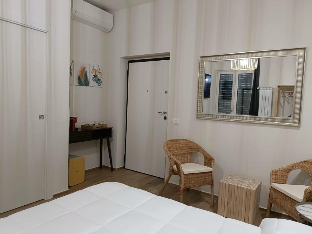 a bedroom with a bed and a mirror and a table at PIANESE house 1 in Campobasso