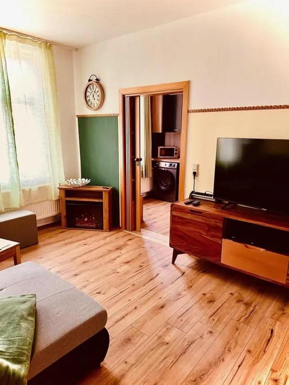 a living room with a large flat screen tv at Haus HarzZauber - Elegantes Ferienquartier in der Altstadt mit Terrasse, Kamin und E-Bikes für die perfekte Auszeit in Wernigerode