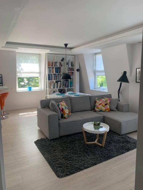 a living room with a couch and a table at Apartament z balkonem in Sopot