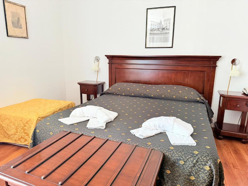 Voodi või voodid majutusasutuse Hotel Archimede Ortigia toas