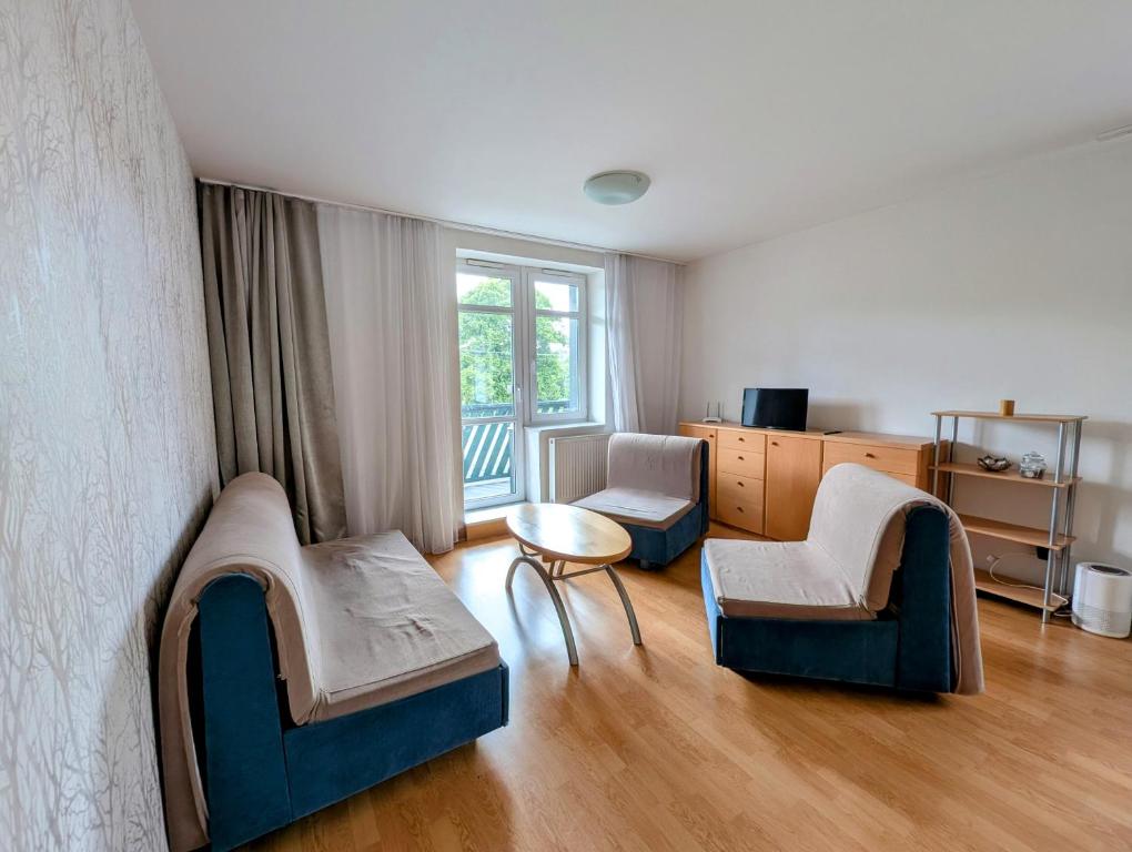 a living room with two chairs and a table at Apartmán Stavidlový Vrch in Vrchlabí